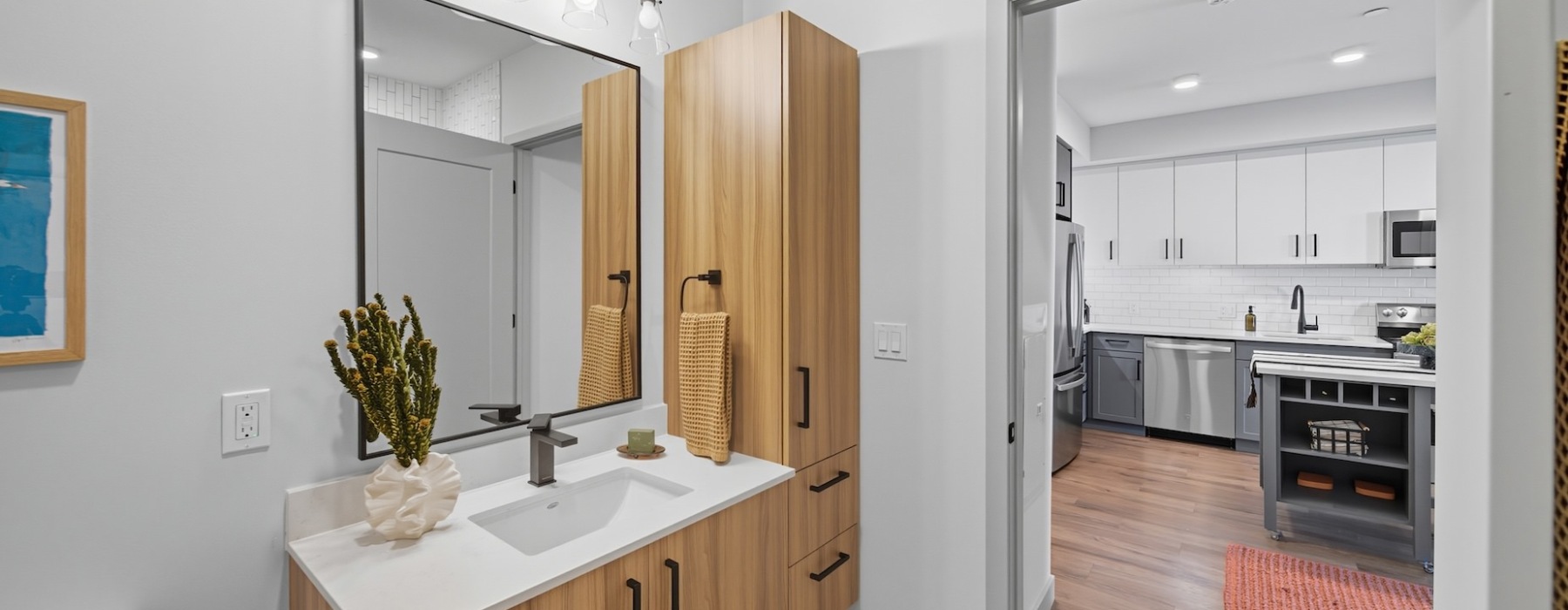 bathroom looking out to kitchen with white cabine